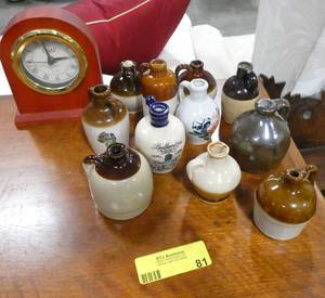 Group of 11 miniature ceramic jugs and a clock