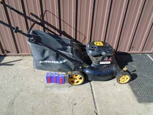 Poulon Pro push mower with bagger. Used condition. Tested & works. As shown.