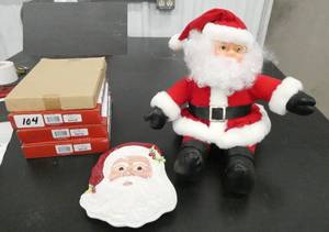 lot 104 image: A stuffed santa and 3 new Santa cookie plates