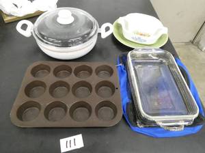 lot 111 image: Kitchen lot with a nice 10 roasting pan, muffin pan, pyrex baking pan and carrying bags, and 2 smaller corelle bowls