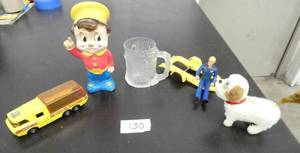 lot 130 image: 1972 Matchbox car hauler, Kelloggs Pop character, a wind up walking dog that works, Flinstones mug, toy trailer and a Tonka man