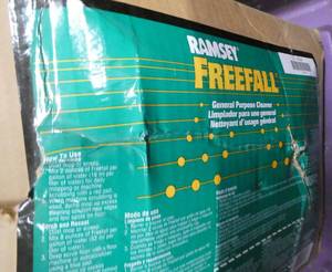 lot 135 image: tote with 5 gallons of Ramsey Freefall general purpose cleaner concentrate, and a hand soap dispenser