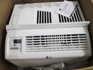 lot 33 image: LG 6K WIND AC, Dented, powers on an...