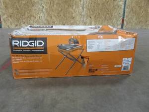 lot 212 image: RIDGID 9 Amp Corded 7 in. Wet Tile Saw with Stand (Broken Drain Plug) Model # R4031S