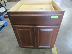lot 210 image: Hampton Bay Assembled 27x34.5x24 in. Base Kitchen Cabinet with Ball-Bearing Drawer Glides in Cognac - Scratch and Dent - Cracked back panel.