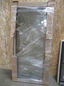 lot 143 image: Simonton Patio Sliding Door. Approximate Dimensions 39 x 79 Fits 77 x 82 14 Frame, Driftwood Vinyl. - Never Installed.