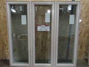 lot 138 image: SIMONTON CUSTOM 6500 Series 3 Lite Double Casement Window, White Vinyl Interior  Driftwood Color Exterior  - 74 12 x 70 14 x 3 18 Wall, With Screens - Never Installed