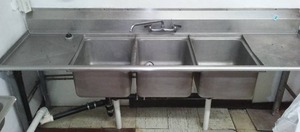 Commercial 3 sink kitchen with counter.