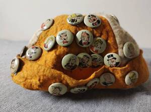 lot 10 image: Vintage Cap Filled with Pinback Buttons from Vintage Comic Book Strips