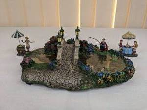 lot 191 image: Lot of (3) Thomas Kinkade Hawthorne Village Collection Figurines  Lamplight Bridge, Nanette and Friend at Tea, Fallbrooke Florist Lady