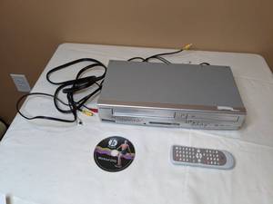 lot 72 image: Combo Sylvania VHSDVD Player with Workout DVD
