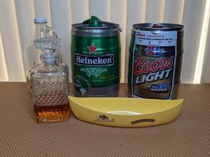 lot 116 image: Beers and Bottles Lot - Empty Mini Kegs, Glass Bottle, Leinenkugels Honey Weiss Decorative Canoe, Decorative Crystal Alcohol Bottle