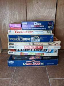 lot 103 image: Assortment of (11) Vintage Board Games - Monopoly, Uno Wild Tiles, Deluxe Wheel of Fortune, Go to the Head of the Class, Payday, ET The Extraterrestrial Card Game, Clue VCR Mystery Game, more