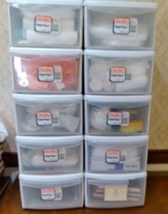 lot 717 image: Plastic Organizer Bins with Drawers Containing Trash Bags, Cleaning Supplies