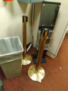 lot 943 image: Set of 2 Gold Stanchion Posts w Retractable Belts, Display Stand, & Trash Can