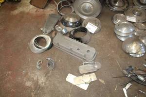 lot 160 image: Lot of Vintage Automotive Parts  - Hub Caps, Valve Cover, HeadlightTaillight Bezels, Mirrors, Grill