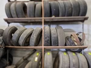 (Lot of 10) Truck Tires and More on Shelf - Has (4) 16 8-Bolt Rims on Left side of Shelf