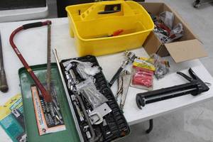lot 156 image: Lot of Hand Tools  - Hand Saw, Caulk Gun, Locking Pliers, Sockets in Metal Case, Tool Caddy with Tools, and more
