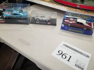 lot 961 image: Lot of (3) Slot Cars 132  - Scalextric Dodge Charger, Porsche 550 Spyder #15 Avus 1955, Plymouth Fury Chrysler Group LLC 2010 Richard Petty #43 - In Display Cases