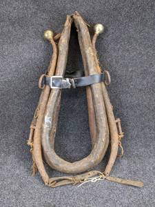 lot 1267 image: Leather Horse Collar with Hames - Measures 17 wide x 29 tall overall. Brass Balls are Attached to Steel Hames.