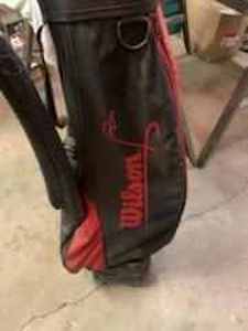 lot 76 image: Golf Clubs and Wilson Bag includes a Tom Daly Driver, 1, 3, and 5 Woods, 3, 4, 5, 7, 8, and 9 Irons