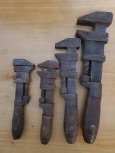 lot 59 image: Four Vintage Wood Handled Pipe Wrenches