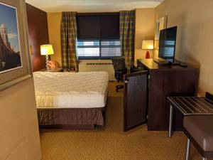 lot 90 image: Room 1203. King Bed, Pedestal Sink, TV 42 LG, Small Safe, and More