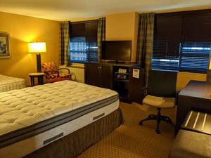 lot 93 image: Room 1204 2 Full Beds,  Elegant Stone Top Table, Chair & Ottoman, Small Safe, 42 LG TV and more