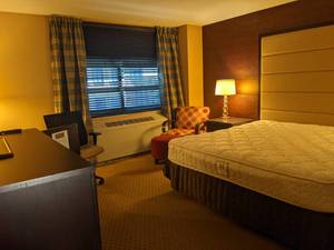 lot 94 image: Room 1206 King bed, 42 LG TV, Small Safe, Side Chair & Ottoman, Desk and More