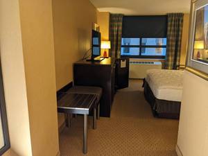 lot 113 image: Room 1105. King Bed, Pedestal Sink, TV 42 LG, Small Safe, & More