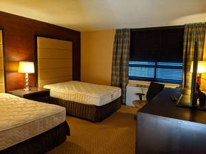 lot 126 image: Room 1118.  2 Full Beds with Headboards, TV 42 LG, Small Safe, Sweeping Arches, and More