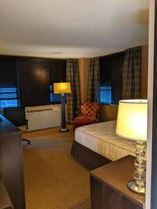 lot 128 image: Room 1120.  King Bed, Mini Fridge, TV 42 LG, Small Safe, Bathroom Accessories, and More