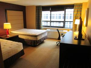 lot 152 image: Room 900. 2 Full beds, Mini fridge, Luggage Bench, Bathroom Accessories, Pedestal Sink, and More 