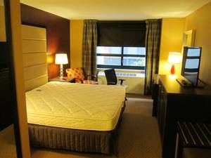 lot 154 image: Room. 903. King bed, Chair, LG TV, Nightstand, Bath Decor, and More 