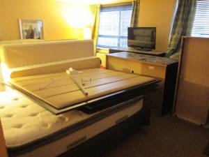 lot 161 image: Room 910. BonusRoom Standard 2 Full Beds, 2 Unique Chairs, Closet storage bench, and more