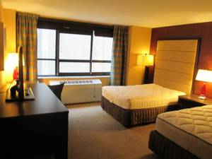 lot 130 image: Room 1001.  2 Full Beds, Mini Fridge, TV 42 LG, Small Safe, Wall Mirrors, Local Artwork, and More