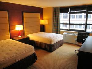 lot 131 image: Room 1000.  2 Full Beds, Mini Fridge, TV 42 LG, Small Safe, Towel Shelf, Framed Local Art, and More