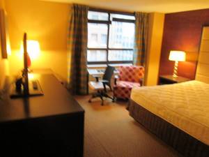 lot 136 image: Room 1006. King Bed, Pedestal Sink, TV 42 LG, Small Safe, & More
