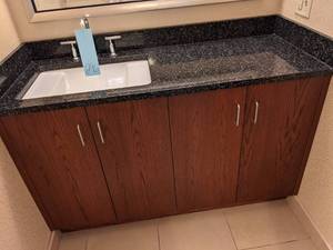 lot 296 image: Classic Black Countertop, Sink, and Cupboards