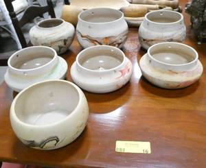 lot 16 image: Lot of 7 Nemadji Indian pottery pieces.  5 of them have holes drilled in them to use as a hanging planter.