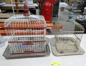 lot 33 image: 2 wire bird cages, the white one is a Hendryx with the original glass feeders, the red and white sure looks like a Hendryx but couldnt make out the tag