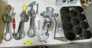 lot 48 image: Kitchen lot of vintage beaters, grinder, cast iron muffin pans, cookie cutters