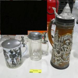 lot 65 image: 3 nice German beer steins, one classic glass one with pewter top, one very tall ceramic and one short with pewter top