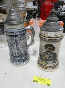 lot 66 image: 2 nice German beer steins, pewter lids, the one with the man looks much better in person, it has gold lines around it that really make it stand out, the blue one is a limited edition