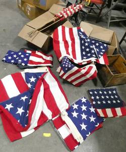 lot 89 image: 9 US flags, the 3 on the poles are in poor condition, the rest are good and are 3x5 ft or larger and not cheap nylon, they are a cotton fabric