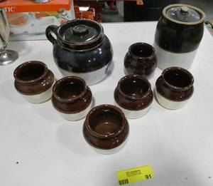 lot 91 image: Very nice group of stoneware bean pot and cups to eat from and a canister