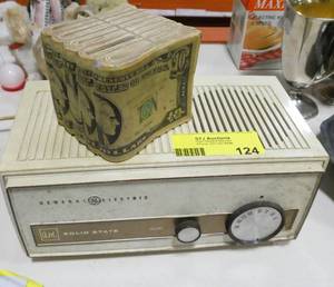 lot 124 image: Vintage GE solid state radio AM only, untested, and a bank of ten dollar bills (plastic)
