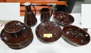 lot 127 image: A beautiful group of brown glazed stoneware bakeware and serveware looks unused.