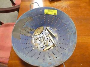 lot 145 image: Old metal strainer with some fishing lures including a red eye wiggler