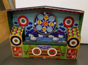 lot 165 image: Tin Wyandotte shooting gallery, 14 wide x 10 tall.  This could easily be a working unit if you replaced the ropestring that goes around the two pulleys and that the ducks attach to.